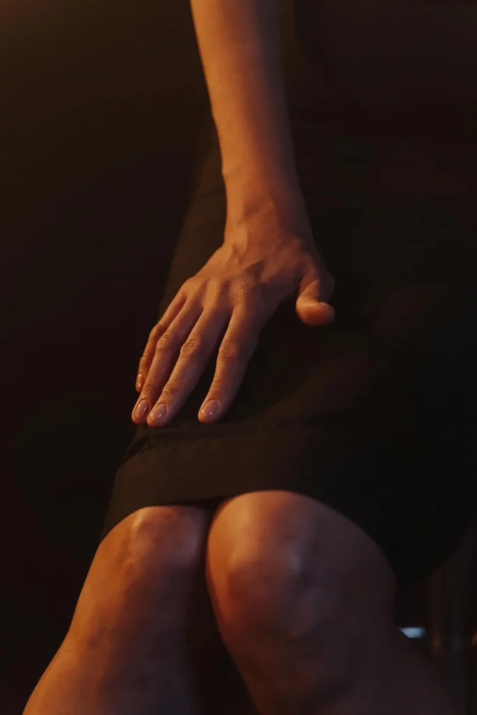 Close-up of a hand resting on a thigh with subtle leg veins showing—an illustration of Second Trimester Visible Veins during pregnancy.