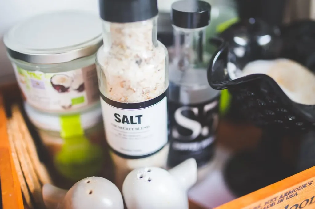 Close-up of a kitchen salt grinder and shakers—reminder to choose iodized salt as an easy, everyday source for Iodine During Pregnancy.
