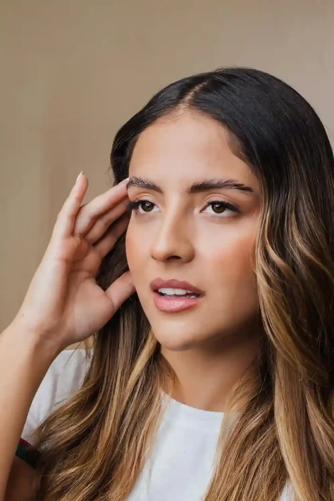 Pregnant woman touching her temples with a light-headed expression—illustrating Second Trimester Dizziness.
