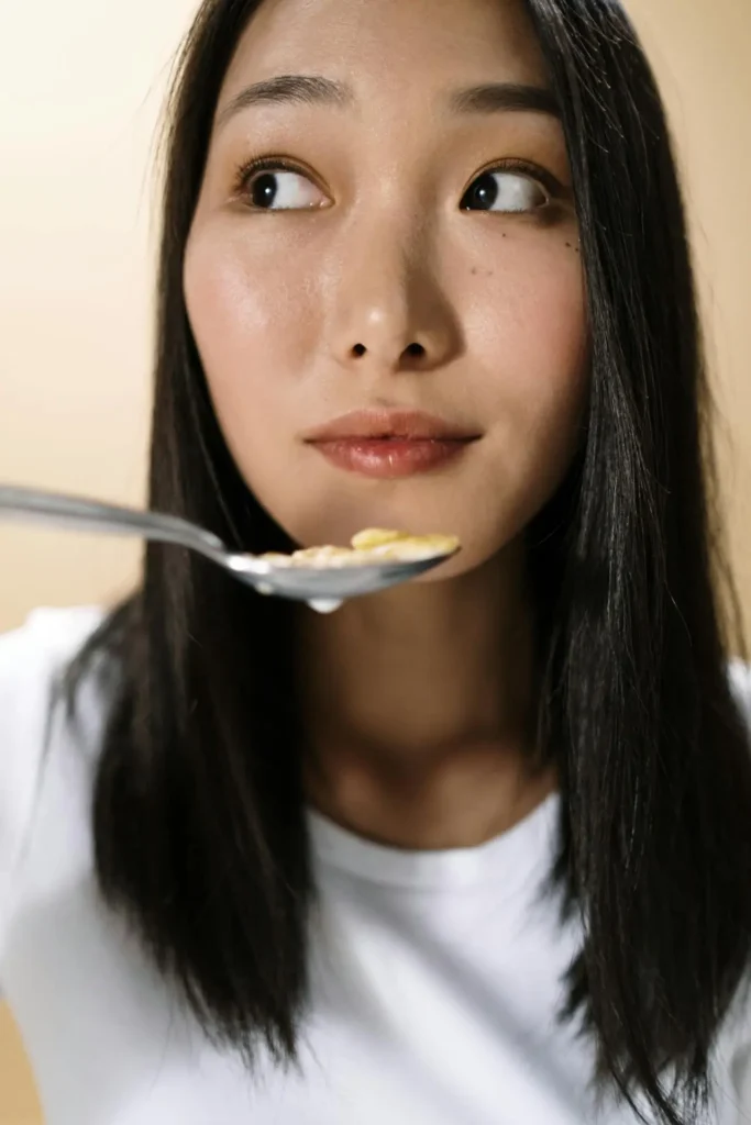 Close-up of a person bringing a spoon toward their mouth, suggesting hunger—visual for Second Trimester Increased Appetite.